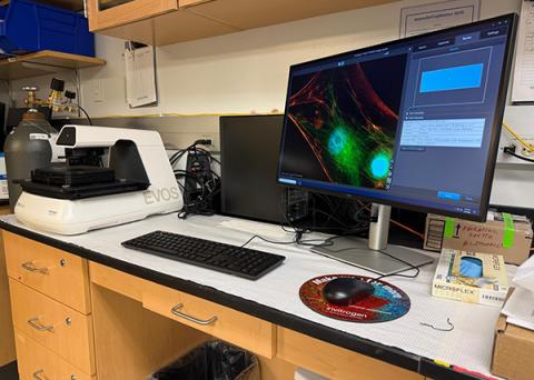 Image of the EVOS 7000 imaging system and monitor sitting on a counter in the lab