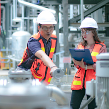 Electricity engineer and his supervisor at industrial facility